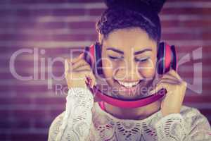 A smiling woman dancing with headphones