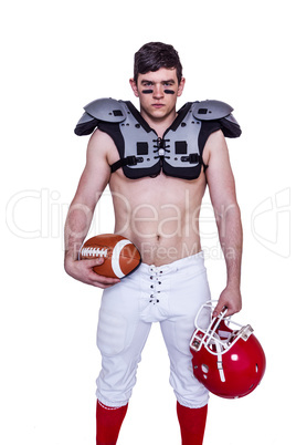 American football player holding a ball and helmet