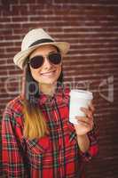Beautiful hipster with disposable coffee
