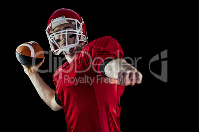 American football player throwing football