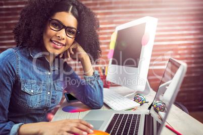 Casual female designer using laptop