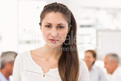 Pretty businesswoman in front of her colleagues Pretty businesswoman in front of her colleagues
