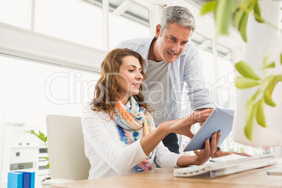 Two casual designers working with tablet