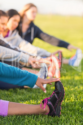 Sporty women stretching during fitness class