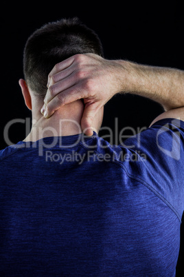 Rear view of a man with neck pain over
