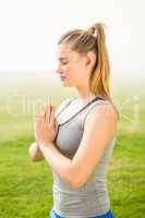 Peaceful sporty blonde meditating