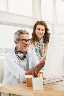 Two casual designers working with computer
