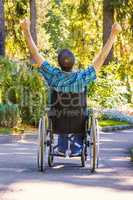 young man in wheelchair with wide opened arms