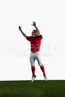 American football player trying to catch football