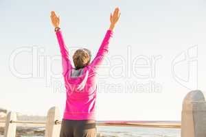 Carefree sporty woman with outstretched arms