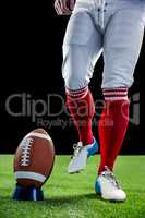 American football player being about to kick football