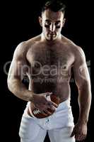 Shirtless American football player with ball