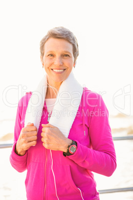Smiling sporty woman listening to music Smiling sporty woman listening to music