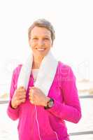 Smiling sporty woman listening to music