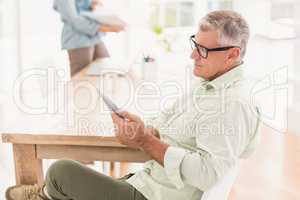 Attentive businessman working on a tablet