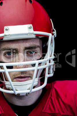 Portrait of focused american football player wearing his helmet