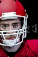 Portrait of focused american football player wearing his helmet