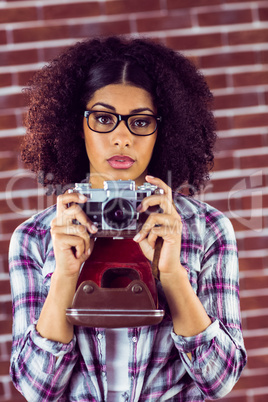 Attractive focused hipster photographing