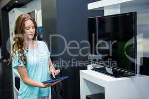 Pretty woman shopping for new television