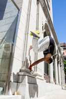 Extreme athlete jumping in the air in front of a building