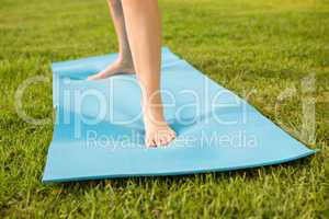 Feet standing on exercise mat