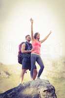 Young happy joggers posing on rock