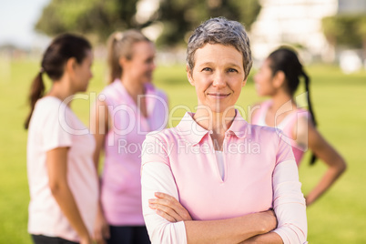 Woman wearing pink for breast cancer in front of friends