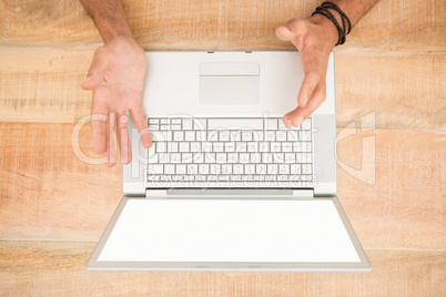 Upset businessman working on blank screen laptop