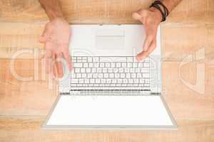 Upset businessman working on blank screen laptop