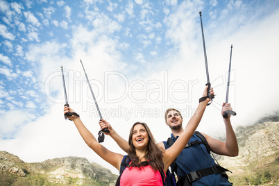 Young happy joggers standing on rock cheering