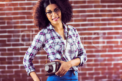 Attractive smiling hipster posing with camera