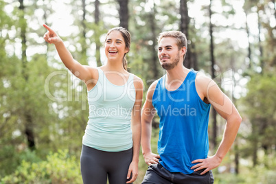 Happy joggers looking away while pointing