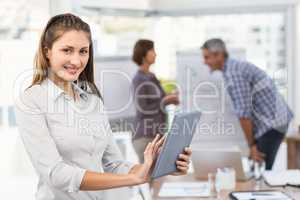 Smiling businesswoman with tablet in a meeting