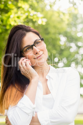 Beautiful brunette making a call in the park