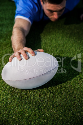 A rugby player scoring a try