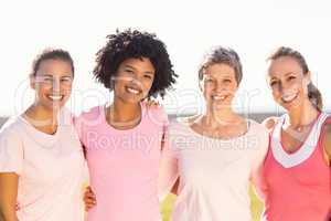 Smiling women wearing pink for breast cancer