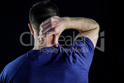 Rear view of a man with neck pain over
