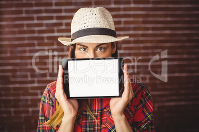 Beautiful hipster showing tablet to camera