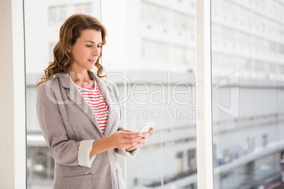 Casual businesswoman using smartphone