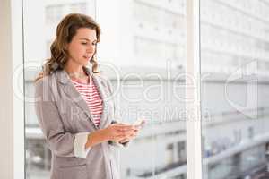 Casual businesswoman using smartphone
