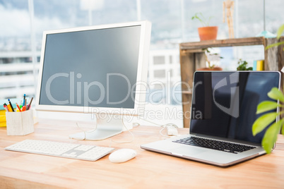 Working desk with computer and laptop