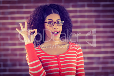 Attractive young woman showing OK sign
