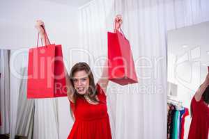 Woman holding up shopping bags