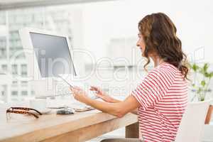 Casual businesswoman working with computer and tablet