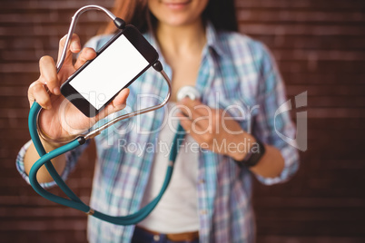 Pretty hipster using her smartphone to diagnose