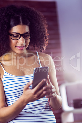 Happy hipster using her phone