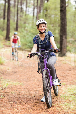 Happy young biker couple looking at camera