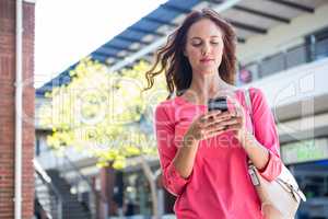 Pretty woman texting at the mall