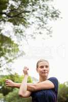 Athletic woman doing arms stretching