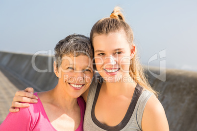 Sporty mother and daughter smiling